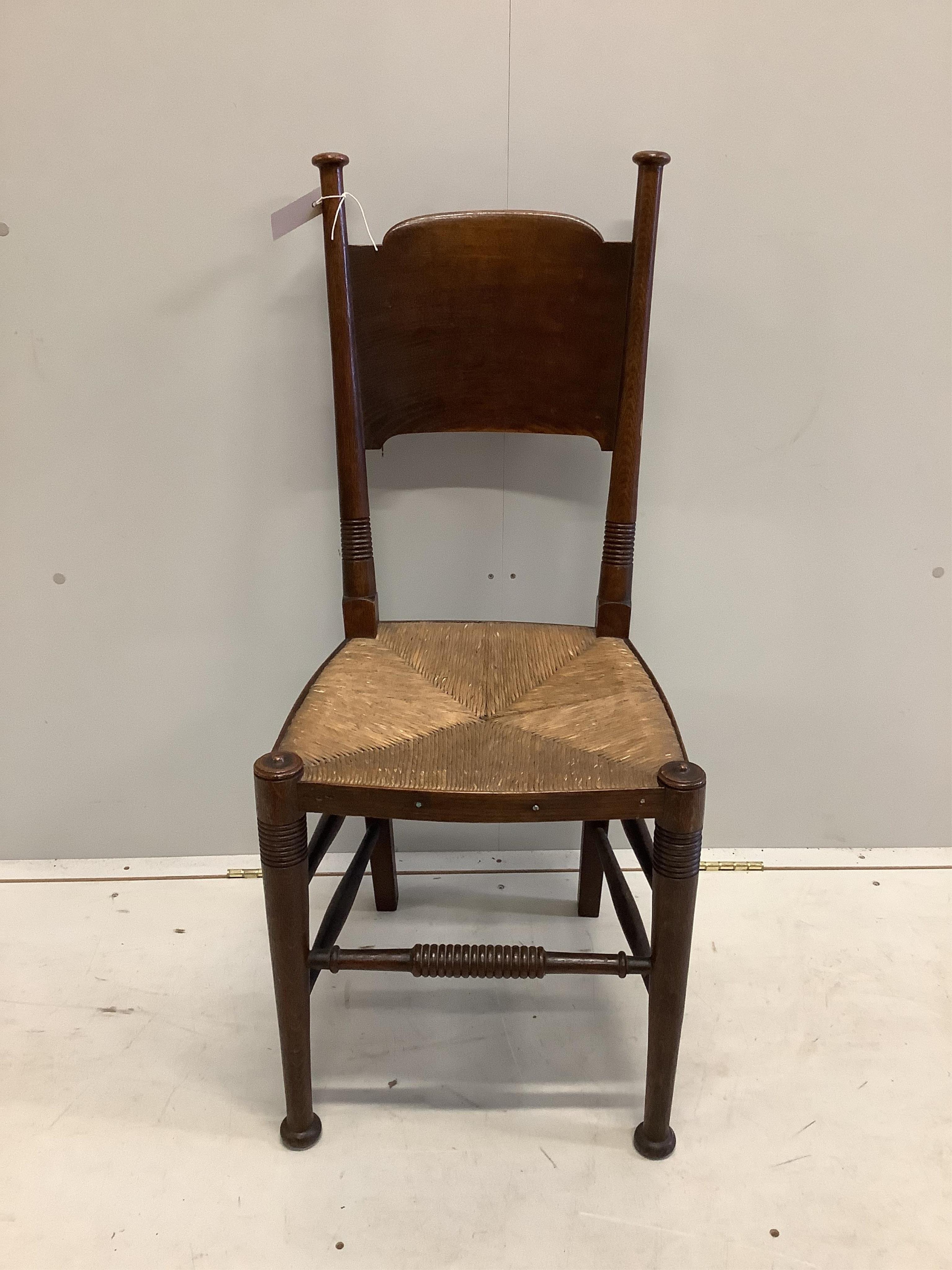 A Liberty & Co William Birch Arts and Crafts oak rush seat chair, width 40cm, depth 40cm, height 98cm. Condition - good.